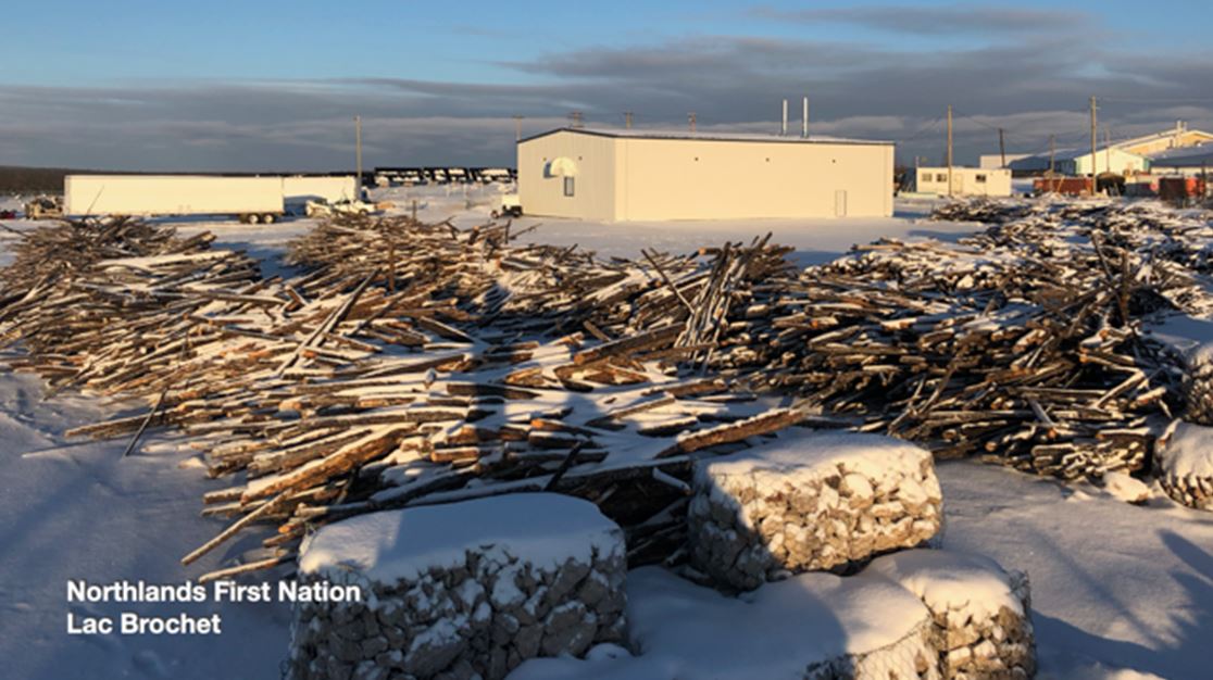 picture of a building surrounded by logs