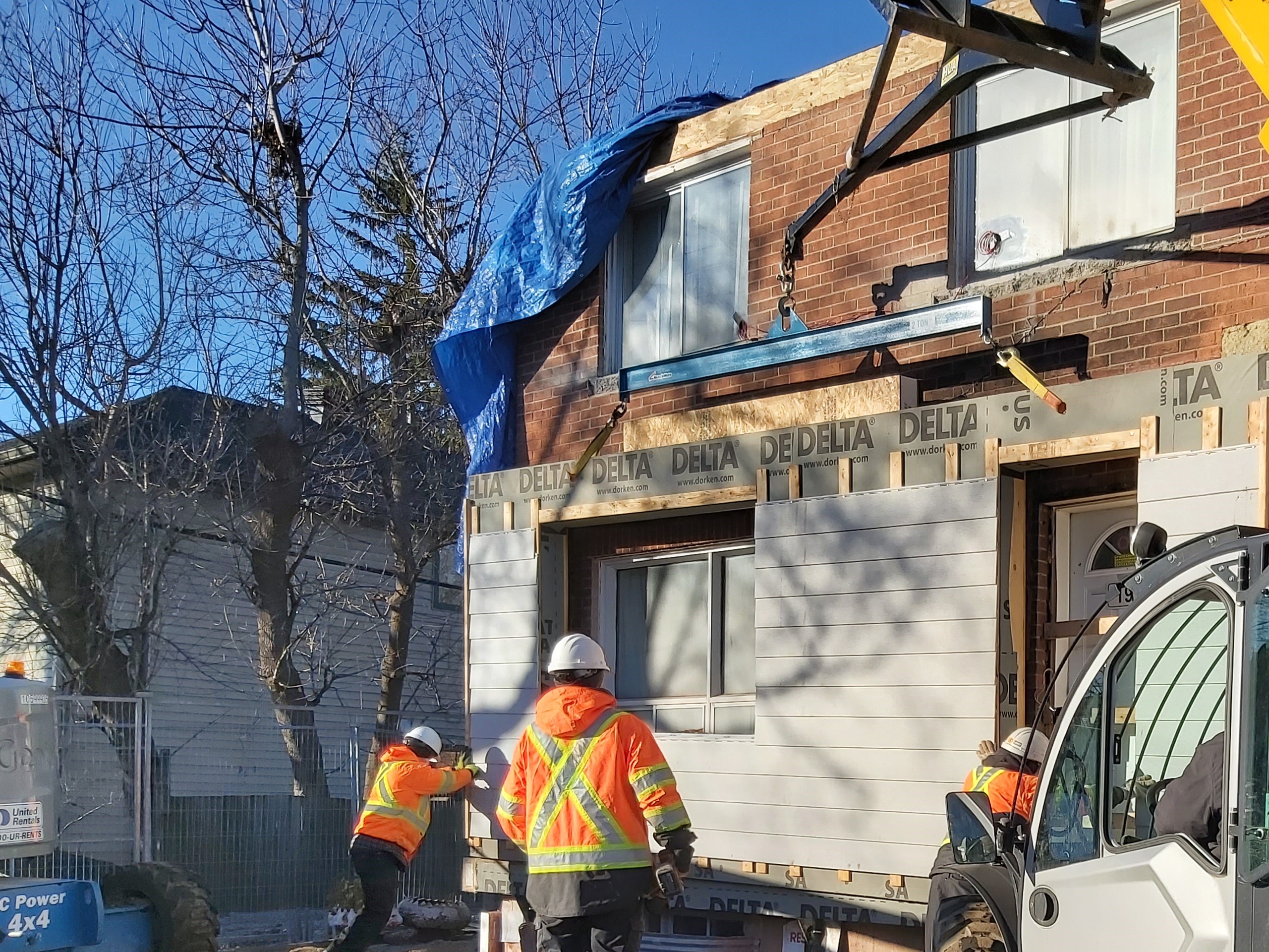 construction workers installing a panel