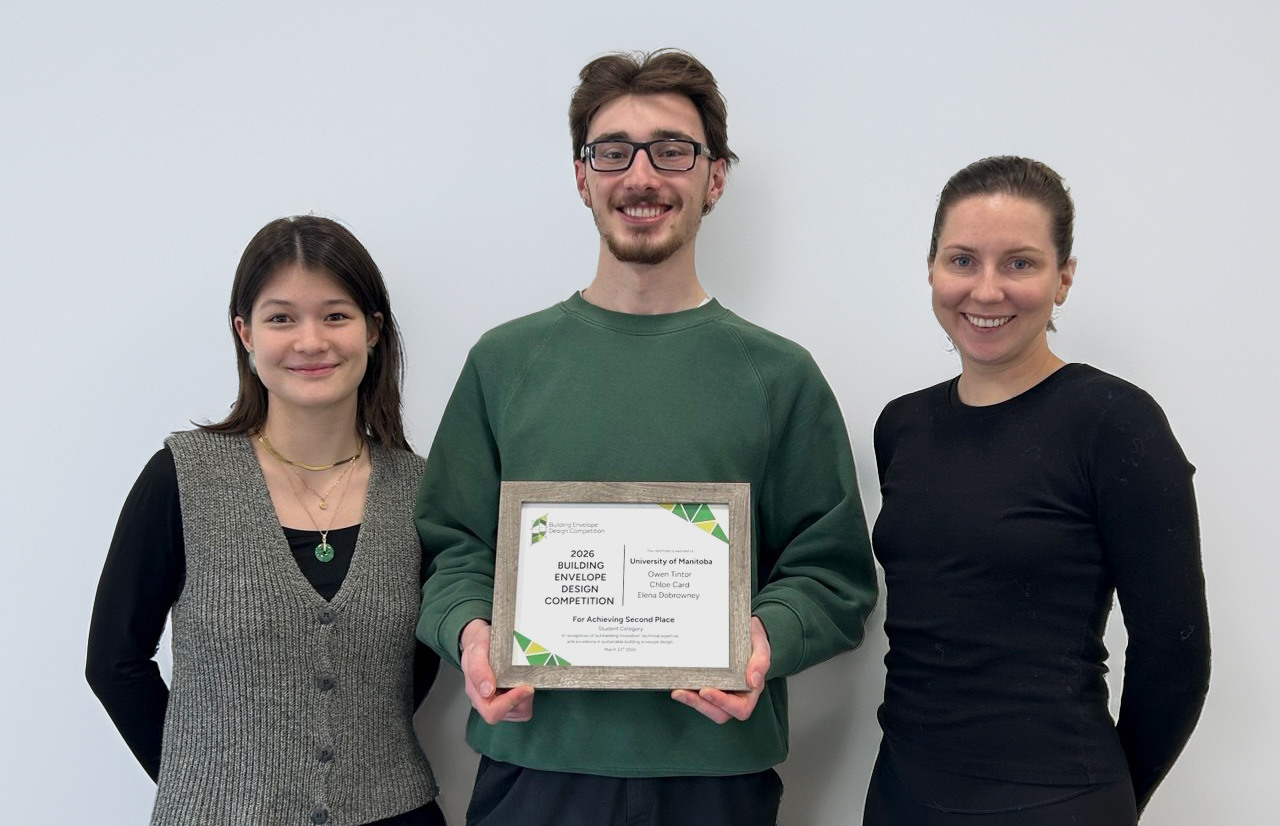 University of Manitoba students, Chloe Tintor and Elena Dobrowney, stand in front of their winning poster. They are holding their frames second place certificate.